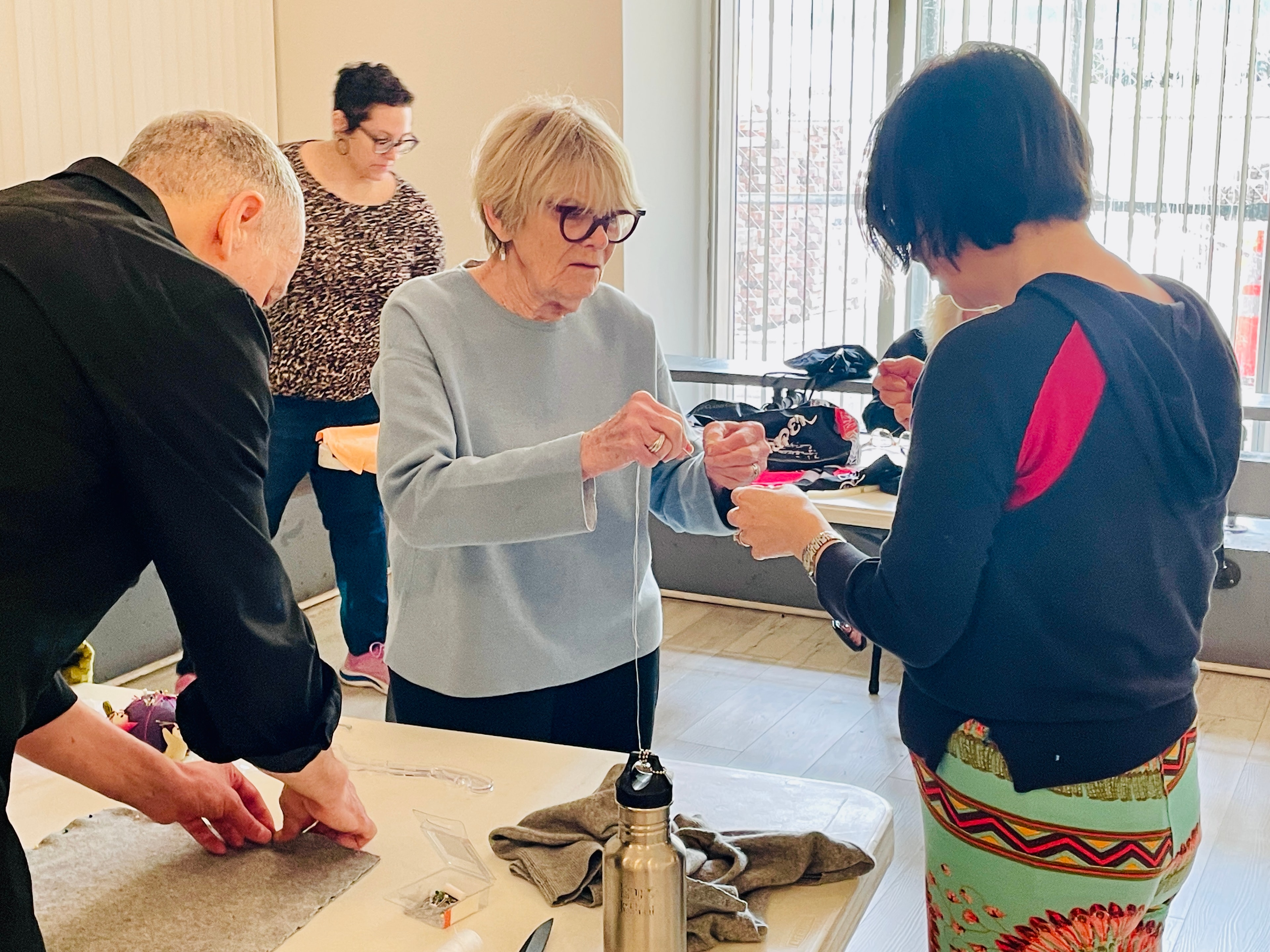 Volunteers sorting and organizing donated clothing at a community center